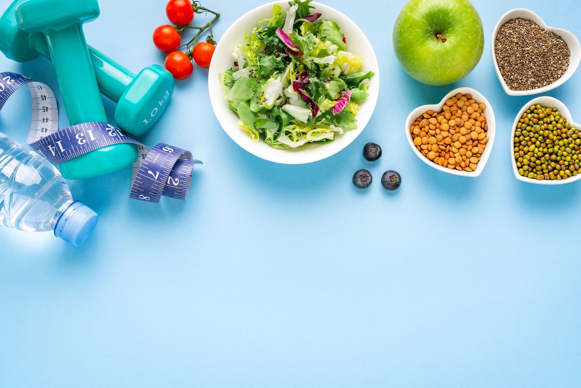 Healthy food and exercising border. Copy space.