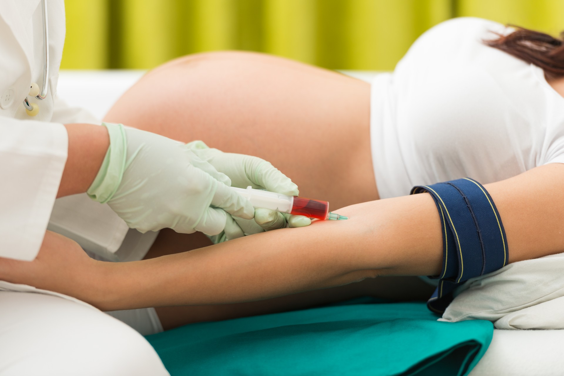 Pregnant woman having her blood taken for blood test